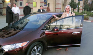 Joan Ogden standing outside a Honda Clarity